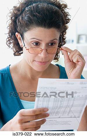 Woman looking at a bank statement View Large Photo Image Stock Image - Woman looking at a bank statement. Fotosearch