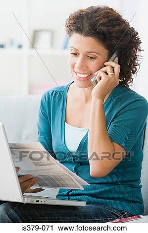 Woman paying bills over the phone View Large Photo Image Stock Image - Woman paying bills over the phone. Fotosearch