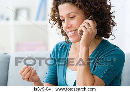 Stock Image - Woman shopping over the phone. Fotosearch