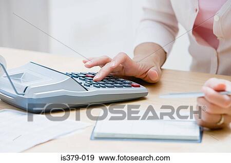 Woman using a calculator View Large Photo Image Stock Photo - Woman using a calculator. Fotosearch