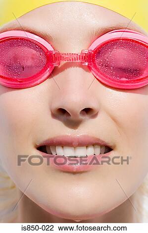 Stock Image - Woman wearing swimming goggles. Fotosearch