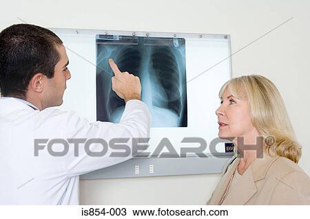 Doctor explaining x-ray to patient View Large Photo Image Stock Image - Doctor explaining x-ray to patient. Fotosearch