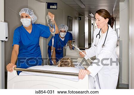Doctors taking child through corridor View Large Photo Image Stock Image - Doctors taking child through corridor. Fotosearch