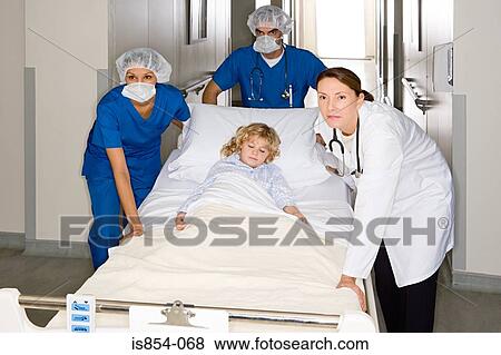 Doctors taking child through corridor View Large Photo Image Stock Photo - Doctors taking child through corridor. Fotosearch
