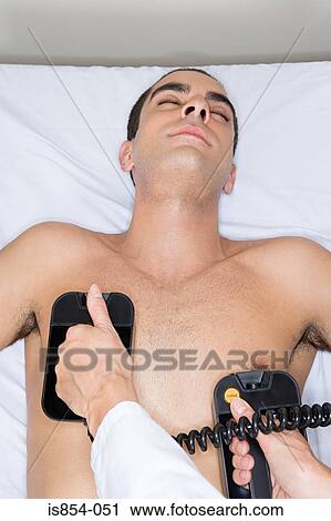 Man having defibrillation View Large Photo Image Stock Image - Man having defibrillation. Fotosearch