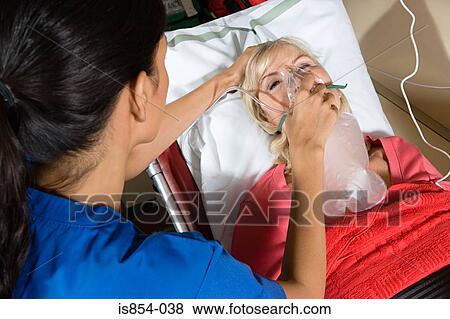 Nurse and patient with oxygen mask View Large Photo Image Stock Photo - Nurse and patient with oxygen mask. Fotosearch