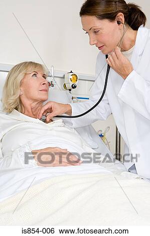 Stock Photograph - Patient and doctor with stethoscope. Fotosearch