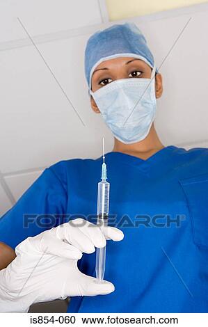 Surgeon with a syringe View Large Photo Image Stock Image - Surgeon with a syringe. Fotosearch