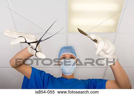 Stock Photography - Surgeon with scalpel and clamp. Fotosearch