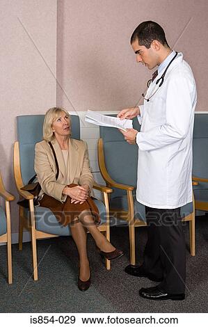 Stock Photo - Woman and doctor with paperwork. Fotosearch