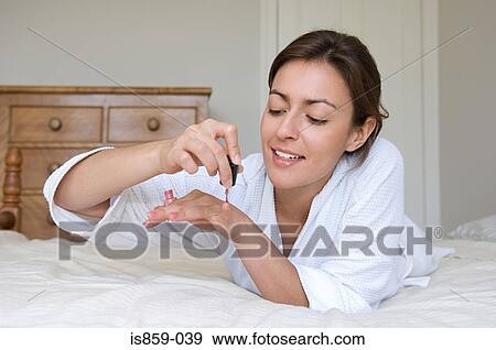 A woman painting nails View Large Photo Image Stock Photo - A woman painting nails. Fotosearch