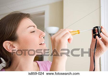 Woman changing fuse on a plug View Large Photo Image Picture - Woman changing fuse on a plug. Fotosearch
