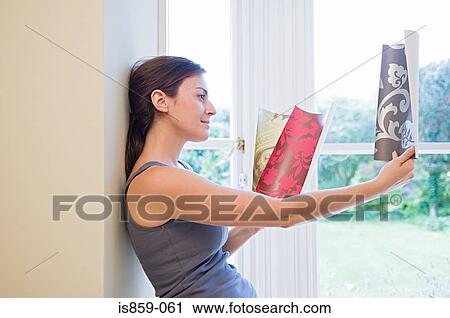 Woman choosing wallpaper View Large Photo Image Stock Image - Woman choosing wallpaper. Fotosearch