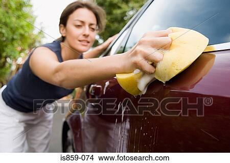 Picture - Woman cleaning car. Fotosearch