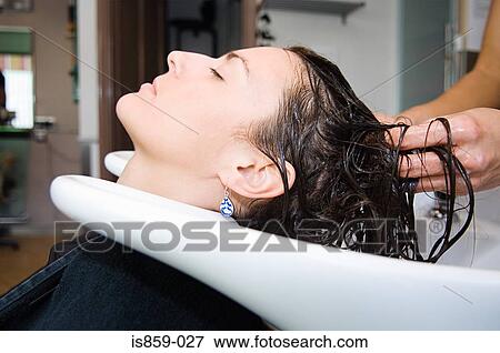 Stock Photo - Woman having hair washed. Fotosearch