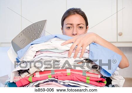 Woman holding stack of ironing View Large Photo Image Stock Photograph - Woman holding stack of ironing. Fotosearch