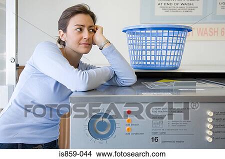 Picture - Woman in a laundrette. Fotosearch