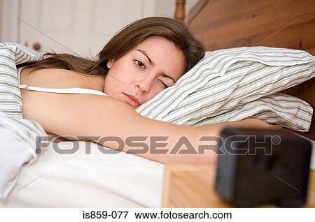 Stock Photo - Woman lying in bed. Fotosearch