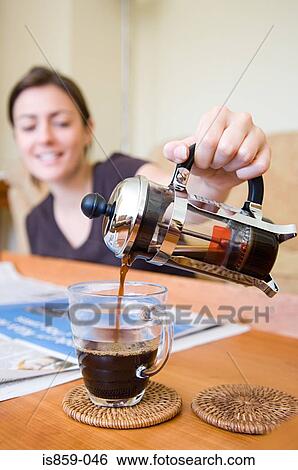 Stock Photograph - Woman pouring coffee. Fotosearch