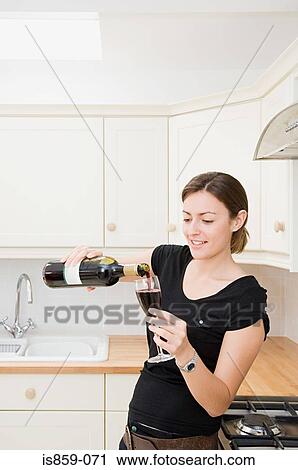 Woman pouring glass of red wine View Large Photo Image Stock Image - Woman pouring glass of red wine. Fotosearch
