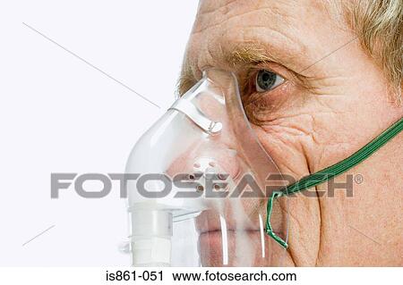 Stock Image - Man wearing oxygen mask. Fotosearch