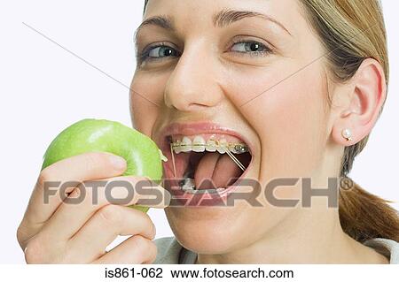 Stock Image - Woman eating apple. Fotosearch