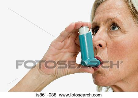 Woman using inhaler View Large Photo Image Stock Photo - Woman using inhaler. Fotosearch