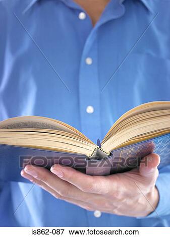 Stock Photo - Man holding a book. Fotosearch