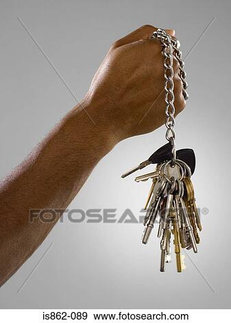Man holding bunch of keys on a chain View Large Photo Image Stock Photo - Man holding bunch of keys on a chain. Fotosearch