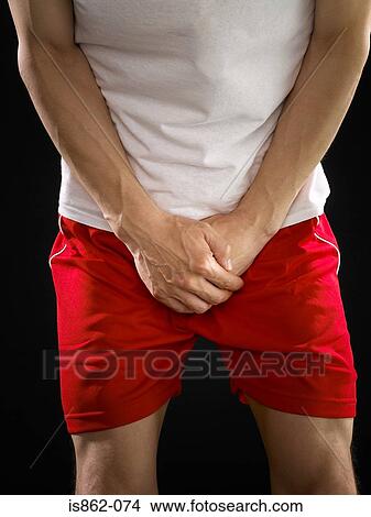 Man with hands covering his crotch View Large Photo Image Picture - Man with hands covering his crotch. Fotosearch