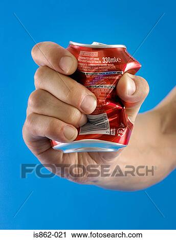 Person crushing a can in their hand View Large Photo Image Stock Image - Person crushing a can in their hand. Fotosearch