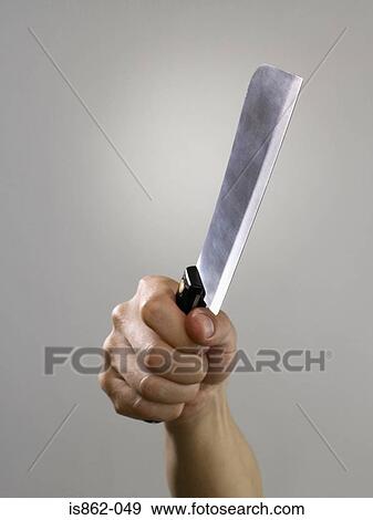 Person holding a cleaver View Large Photo Image Stock Photo - Person holding a cleaver. Fotosearch