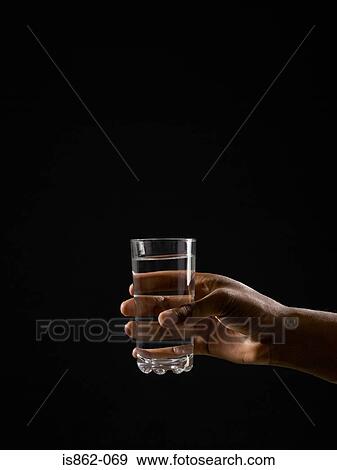 Person holding a glass of water View Large Photo Image Stock Photo - Person holding a glass of water. Fotosearch