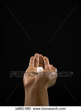 Person holding a sugar cube View Large Photo Image Stock Image - Person holding a sugar cube. Fotosearch