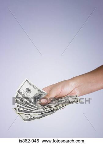 Stock Photograph - Person holding banknotes. Fotosearch