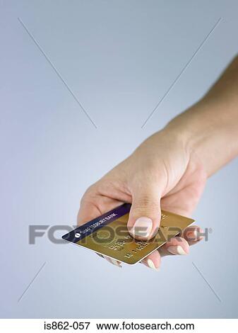 Stock Photo - Person holding credit card. Fotosearch