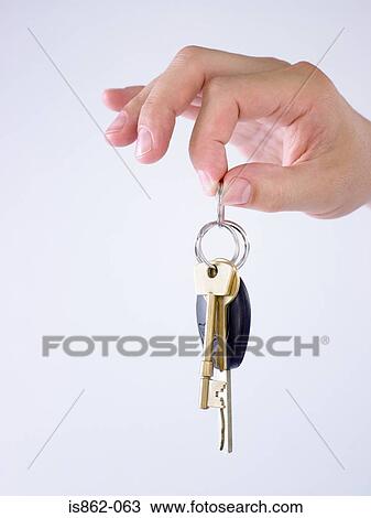 Stock Image - Person holding keys. Fotosearch