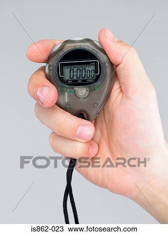 Stock Image - Person holding stop watch. Fotosearch