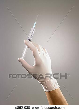 Person holding syringe View Large Photo Image Stock Image - Person holding syringe. Fotosearch