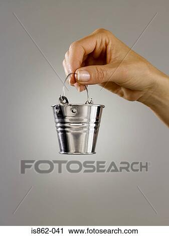 Woman holding a small bucket View Large Photo Image Stock Image - Woman holding a small bucket. Fotosearch