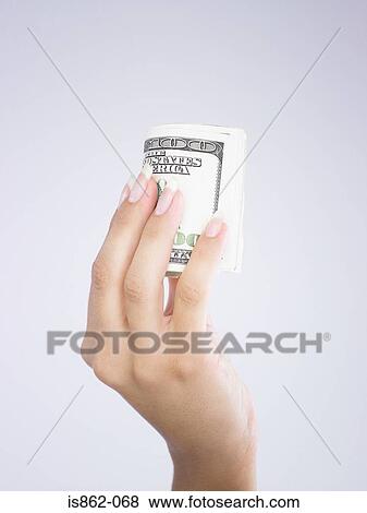 Woman holding roll of banknotes View Large Photo Image Stock Photo - Woman holding roll of banknotes. Fotosearch