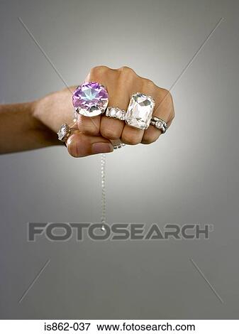 Woman wearing rings on her fingers View Large Photo Image Stock Photo - Woman wearing rings on her fingers. Fotosearch