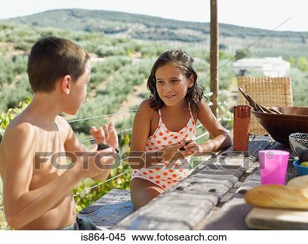 Boy and girl at picnic table View Large Photo Image Stock Photography - Boy and girl at picnic table. Fotosearch