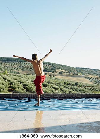 Boy jumping into swimming pool View Large Photo Image Stock Photo - Boy jumping into swimming pool. Fotosearch