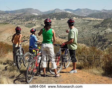 Cyclist family looking at view View Large Photo Image Picture - Cyclist family looking at view. Fotosearch