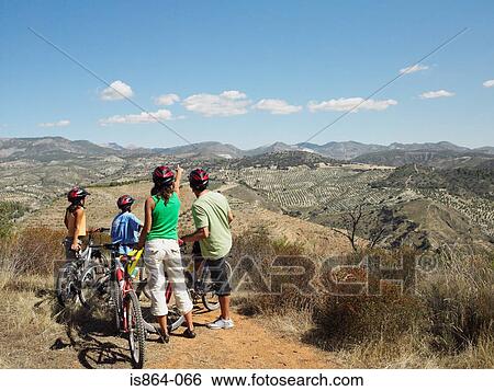 Cyclist family looking at view View Large Photo Image Stock Photograph - Cyclist family looking at view. Fotosearch