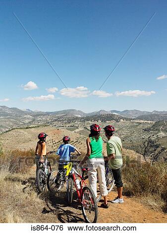 Cyclist family looking at view View Large Photo Image Stock Photograph - Cyclist family looking at view. Fotosearch