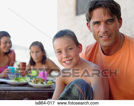 Stock Photo - Father and son at meal outdoors. Fotosearch