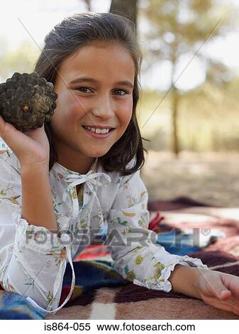 Stock Photography - Girl holding a pine cone. Fotosearch