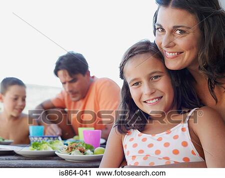 Stock Image - Mother and daughter at meal outdoors. Fotosearch